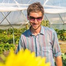 Cameron Willingham, a research technician for UAF's School of Natural Resources and Agricultural Sciences, helps keep the research garden looking great during its late-summer glory.